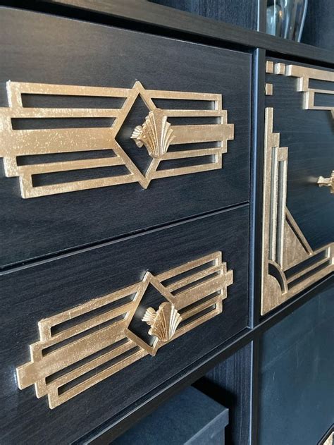 Two Black Drawers With Gold Designs On The Front And Side Panels One