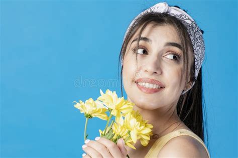 Stylish Brunette Woman With Ponytail Smiling Holding Yellow Flower