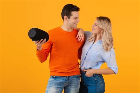 Free Photo Beautiful Smiling Young Couple Holding Wireless Speaker