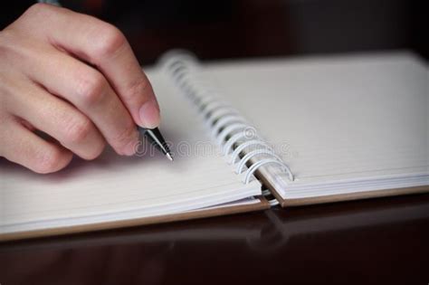 Escritura De La Mano Con Una Pluma En Un Cuaderno Imagen De Archivo