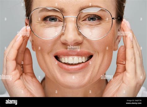 Joyous Beautiful Woman With Blonde Collected Hair And Glasses Smiling