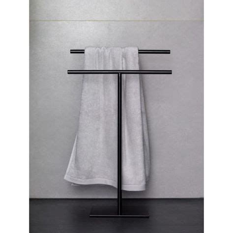 A Towel Rack With Two Towels Hanging From It S Sides In Front Of A