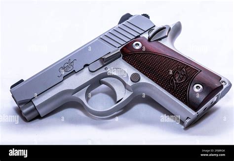 A Stainless Steel Kimber 380 Micro 1911 Pistol With Wooden Grips Stock