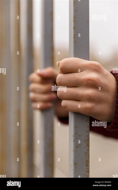 Hands Behind Bars Stock Photo Alamy