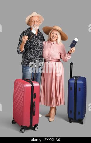 mature couple  passports  suitcases  yellow background travel