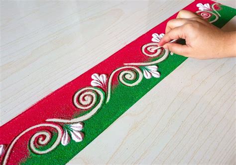 someone is painting the side of a red and green christmas ribbon with ...