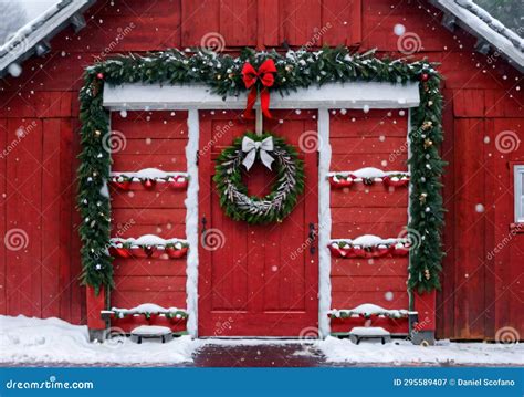 A Christmas Themed Wreath On A Red Barn Door During A Snowy Evening