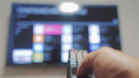 Smart Tv With Apps And Hand Male Hand Holding The Remote Control Turn