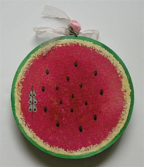 A Watermelon Ornament Hanging On A Wall