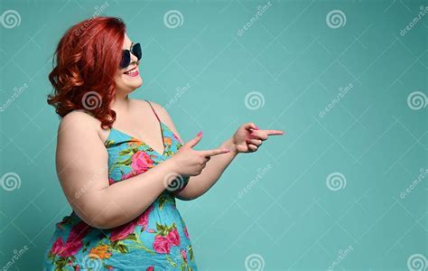 Plus Size Overweight Redhead Lady In Sunglasses Shows A Gesture Sign Finger Gun Aimed At Free