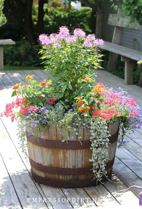 22 Creative Planters Wagons Whiskey Barrels And Wheels Whiskey Barrel Planter Flowers Whiskey