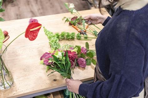 Premium Photo Midsection Of Florist Holding Flower At Shop