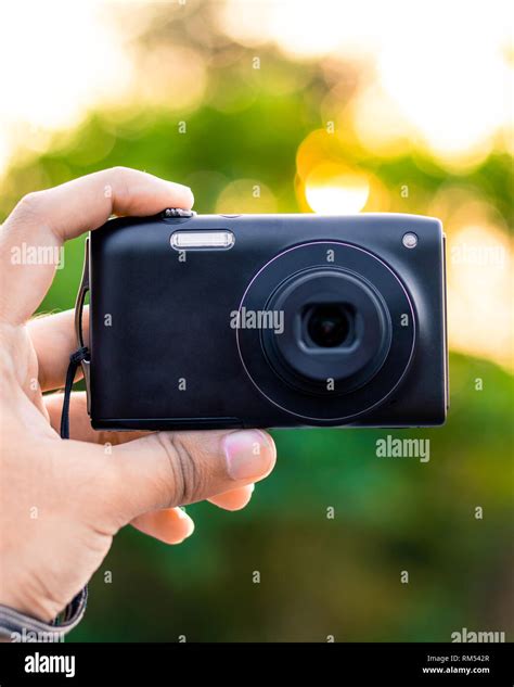 small black digital camera   hand stock photo alamy