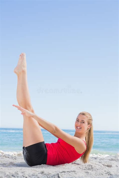 Athletic Blonde Doing Pilates Core Exercise Smiling At Camera Stock