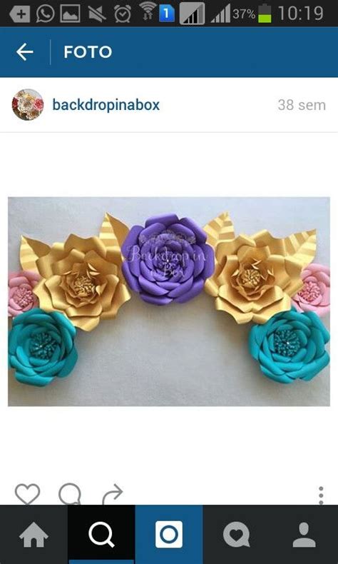 Three Paper Flowers On Top Of Each Other In Blue Pink And Yellow