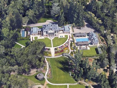 An Aerial View Of A Large Home Surrounded By Trees