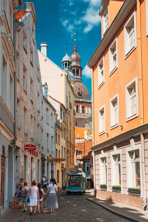 Riga Latvia People Walking On Narrow Cobbled Kramu Street Of Old Town