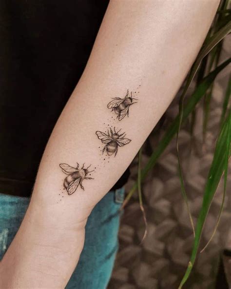 Three Bees Tattoo On The Right Arm And Left Arm With One Flying Away