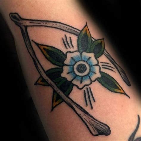 A Tattoo With An Arrow And Flower On It