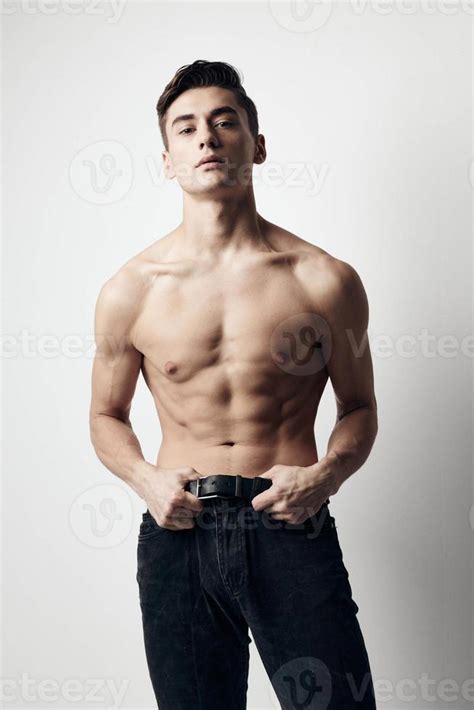 A Guy With A Naked Torso And In Jeans On A Light Background Cropped View Stock Photo At