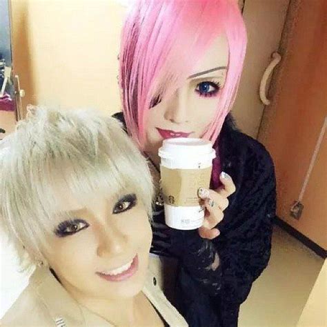 Two Women With Pink Hair Holding Coffee Cups