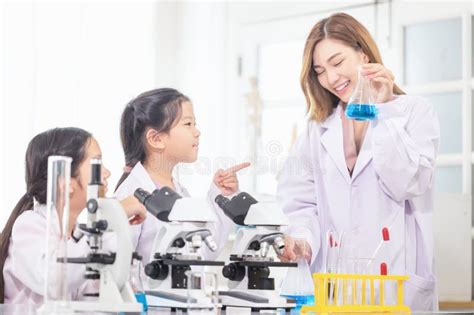 Elementary Science Class Cheerful Kids Girl With Teacher Scientist In