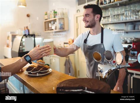 Happy Barista Serving Coffee To Customer At Cafe Stock Photo Alamy