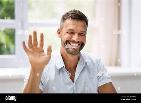 Man Portrait Waving Hello In Video Conference Stock Photo Alamy