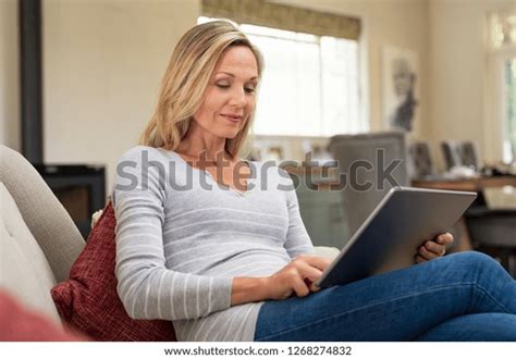 Beautiful Mature Woman Sitting On Couch Stock Photo Edit Now 1268274832