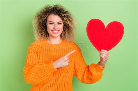 Photo Of Impressed Blond Lady Index Heart Wear Orange Sweater Isolated