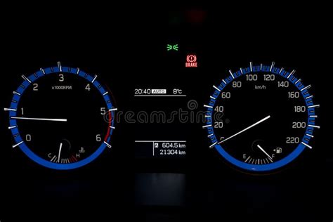 Backlit Gauges Of An Automobile Blue Glowing Meters With A Whit Stock