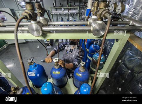 Indonesian Navy Officers Fill Oxygen Cylinders In The Warship KRI Dr