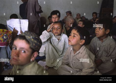 Young Afghan refugee children receiving a few hours basic education ...