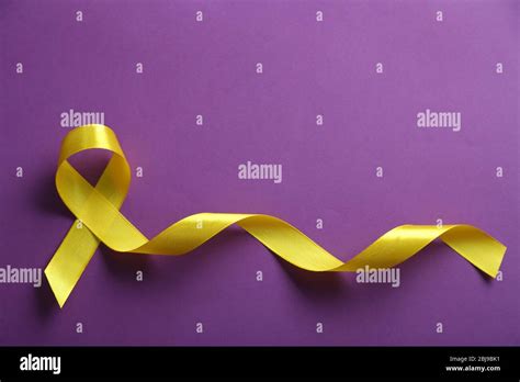 Yellow Ribbon On Purple Background Stock Photo Alamy