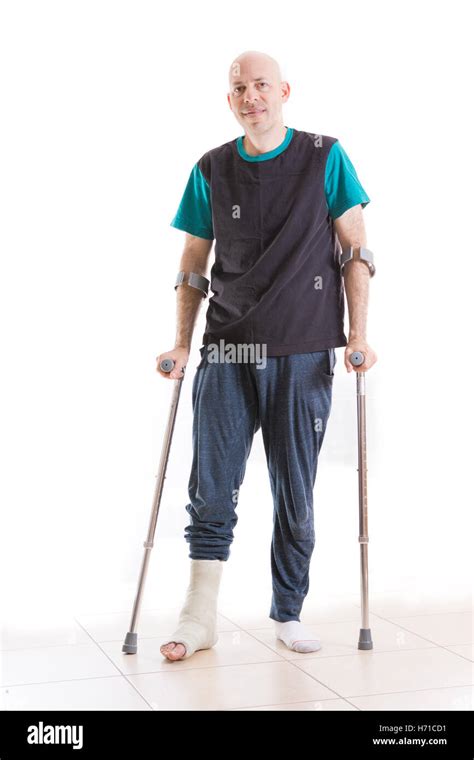 Young Man With A Broken Ankle And A Fiberglass And Plaster Cast On His