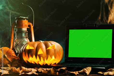 Halloween pumpkins and laptop with green screen in scary deep night ...