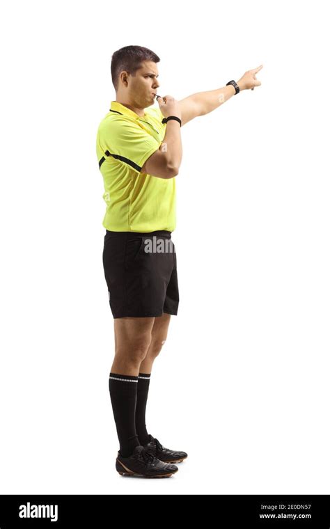 Side View Of A Football Referee Blowing A Whistle Isolated On White