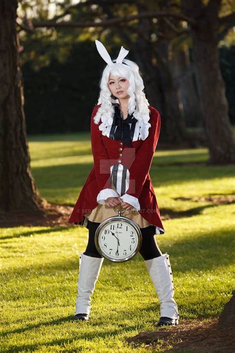 A Woman In Bunny Ears Is Holding A Clock