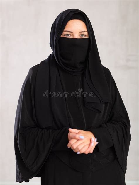 muslim woman  face covered  burka holds thin fabric  yashmak