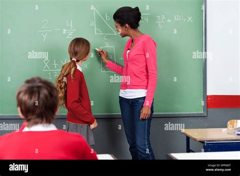 Teacher Teaching Mathematics To Students On Board Stock Photo - Alamy