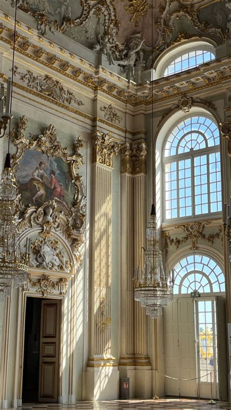 An Ornately Decorated Room With Chandeliers And Paintings On The Walls