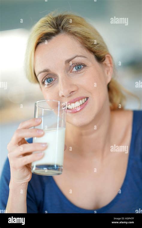 Portrait Of Blond Mature Woman Drinking Milk From Glass Stock Photo Alamy