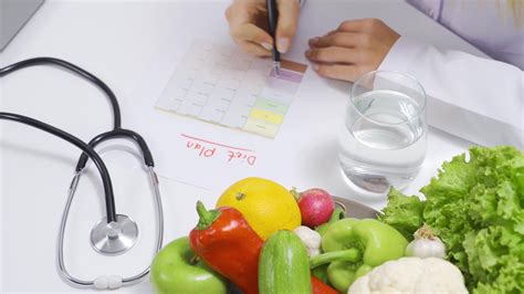 Nutritionist woman prepares diet plan for healthy life at table