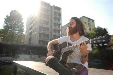 Man In White Shirt Playing Acoustic Guitar · Free Stock Photo