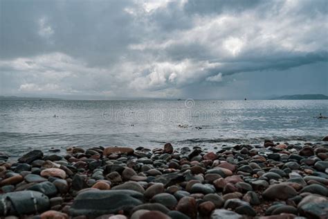 North Sea View With Pebble Beach On A Gloomy Day Cloudy Sky Reflecting