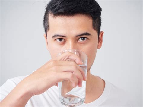 Premium Photo Handsome Young Man Drinking Water