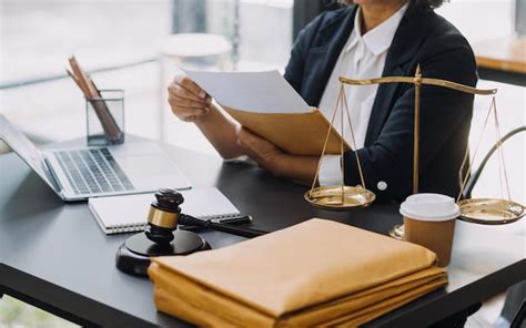 Premium Photo Law Books And Scales Of Justice On Desk In Library Of