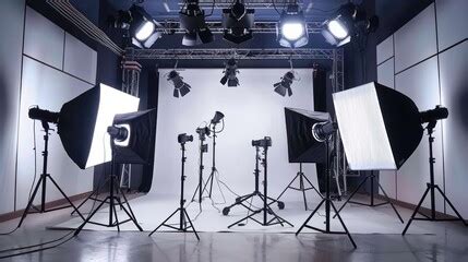 A professional photographerâ€™s studio set up for corporate headshots with lighting and backdrops