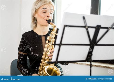 Saxophonist Woman With Her Musical Instrument At The Window Stock Image