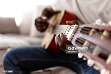 Black Person Tuning Guitar Photos and Premium High Res Pictures - Getty ...